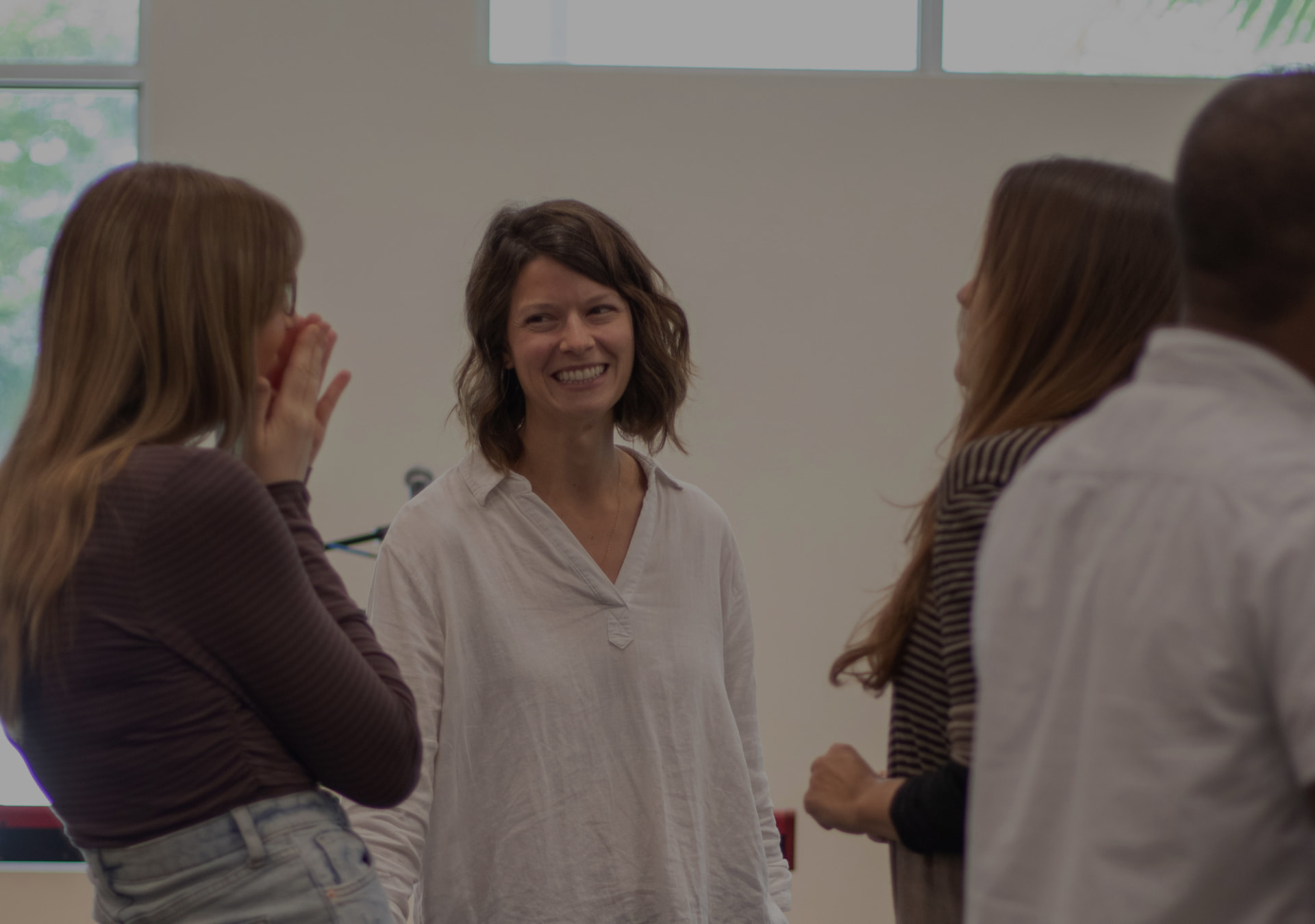 Members of Faith Church Miami talking and laughing together after a service